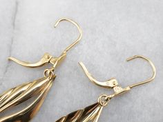 Sleek and polished, these stylized teardrop gold earrings are an absolute classic. Hung on simple lever back findings, these are versatile and lovely, easy to transition from casual to formal wear! Metal: 18K Yellow Gold Earrings Length: 41 mm Earrings Width: 10 mm Marks: "750" Stamped on the Findings Formal Gold Teardrop Earrings With Lever Back, Formal Teardrop Lever Back Earrings, Formal Pear-shaped Teardrop Earrings With Lever Back, Yellow Gold Teardrop Earrings With Lever Back, Classic Formal Teardrop Earrings With Lever Back, Formal Yellow Gold Hypoallergenic Teardrop Earrings, Formal Hypoallergenic Yellow Gold Teardrop Earrings, Classic Teardrop Earrings With French Hook For Formal Occasions, Yellow Gold Teardrop Earrings With French Hook