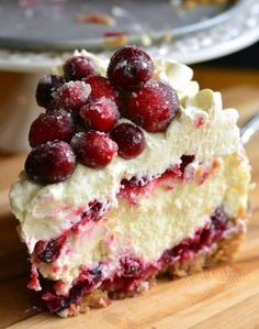 a close up of a piece of cake on a wooden cutting board with a fork