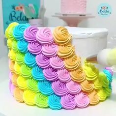 there is a cake made to look like a rainbow wave with icing on it