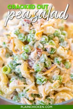 a bowl filled with pasta salad on top of a wooden table