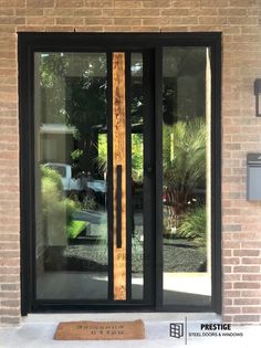 the front door to a house with glass and wood