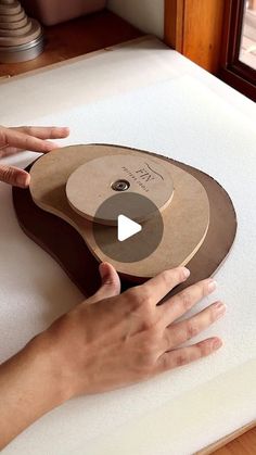 a person's hand on top of a mattress with a piece of cardboard attached to it