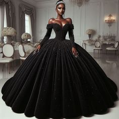 a woman in a black ball gown standing in front of a table with chairs and chandelier