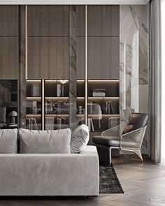 a white couch sitting in front of a book shelf