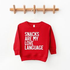 Looking for a cute sweatshirt for your kids? We have the perfect Snacks Are My Love Language graphic sweatshirt addition to their closet! Also available in youth sweatshirts. Holiday Sweatshirt Ideas, Playful Red Sweatshirt For Fall, Playful Long Sleeve Sweater With Letter Print, Playful Red Cotton Sweatshirt, Toddler Cricut Shirts, Cricut Sweatshirt Ideas, Perfect Snacks, Baby Cam, Valentines Sweatshirt