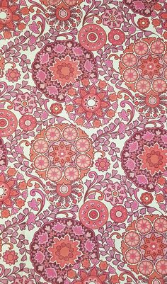 an orange and pink flowered pattern on fabric