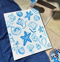 a blue and white paper with sea animals on it next to a bottle of water