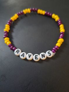 a beaded bracelet with the word raven's spelled in white letters on it