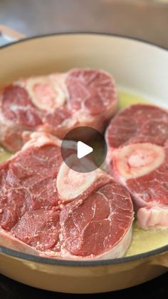 raw meat being cooked in a skillet