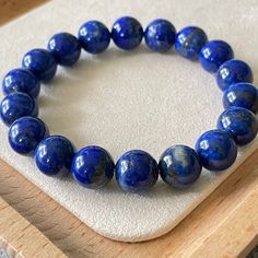 💡Good to Know: *  The photo shows the actual stone bracelet you'll receive. *  We pour our hearts into crafting each bracelet, lovingly made one by one. 🔮Key Details: *  Bracelet diameter: 15cm (~6 inch) *  Bead size: 10mm *  Weight: 15.5g 🪬Healing Properties: *  Wisdom and Clarity *  Inner Peace and Serenity *  Communication and Expression 🚚Shipping: *  We ship worldwide. *  All orders will ship within 2 business days. *  Tracking information will be provided once your order is shipped. * Natural Lapis Lazuli Bracelets, Gift Lapis Lazuli Round Bead Bracelets, Lapis Lazuli Bead Bracelet Gift, Gift Lapis Lazuli Bracelets With Round Beads, Lapis Lazuli Bracelet, Peace And Serenity, Quartz Bracelet, Key Details, Rutilated Quartz