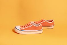 "Lovely bright orange & white Fila sneakers with bright orange laces, blue & orange stripes and white trim.  ➽ tag: Fila ➽ material: poly outer, man made material sole ➽ condition: good shape, has wear at sole and some staining at the fabric ➽ size: 6 ➽ measures: sole width 3 1/2\" / sole length 10\" / shoe height 3\" / heel height 1 1/2\" ➽ Apple Branches Vintage applebranchesvintage.etsy.com instagram.com/applebranchesvtg" Casual Orange Sneakers With Gum Sole, Orange Canvas High-top Sneakers, Orange High-top Canvas Sneakers, Casual Orange Sneakers With Rubber Sole, Orange Lace-up Sneakers With Elastic Laces, Orange Elastic Lace-up Sneakers, Retro Orange Sneakers With Gum Sole, Casual Orange Sneakers With Vulcanized Sole, Orange Sneakers For Summer Streetwear