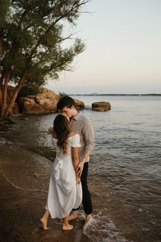 a man and woman are standing in the water