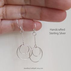 We create 925 sterling silver jewelry for you. This simple versatile Two Circle of Love design celebrates vibes of life. Featuring fine chain and double circle drop.  They are so simple, unique and lightweight. Versatile and Elegant Design Multiple piercings. Large Circle: 17 mm Small Circle: 11 mm Drop length: 4.5 cm     All made from 925 sterling silver.  No nickel or steel. Not silver plated. Unfortunately, earrings cannot be returned due to hygiene reasons. Matching necklace: https://www.etsy.com/uk/listing/1113758787 More Earrings: https://www.etsy.com/uk/shop/JewelleryCraftbyKC?ref=simple-shop-header-name&listing_id=729394742&section_id=27383132 Sterling Silver Necklace: https://www.etsy.com/uk/shop/JewelleryCraftbyKC?ref=simple-shop-header-name&listing_id=729394742&section_id=273831 Everyday Sterling Silver Dangle Jewelry, Gift Sterling Silver Hoop Earrings Stamped 925, Stamped 925 Sterling Silver Drop Earrings, Sterling Silver Dangle Earrings Fine Jewelry, Sterling Silver Jewelry With Ear Wire For Anniversary, Sterling Silver Pierced Earrings For Anniversary, Sterling Silver Jewelry With Matching Earrings For Anniversary, Pierced Sterling Silver Anniversary Earrings, Sterling Silver Matching Earrings For Anniversary