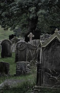 an old cemetery with tombstones and trees in the background