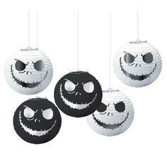 four halloween lanterns with faces hanging from the ceiling and one has sunglasses on it's head