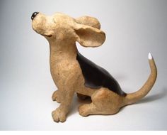 a ceramic dog figurine sitting on the ground