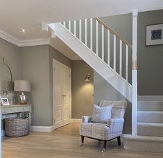 a living room filled with furniture and a stair case