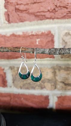 These stunning genuine inlaid malachite teardrop hoop earrings are set in 925 sterling silver, combining natural beauty with bohemian flair. Each earring, measuring 1" in height, features a striking malachite design that showcases its rich, green hues and unique banding patterns. Handmade with precision, these earrings offer a chic and artisanal touch, making them an ideal gift for her. Their natural stones and elegant teardrop shape capture a sense of effortless style, perfect for adding a touch of bohemian sophistication to any outfit. Green Teardrop Hoop Earrings, Teardrop Inlay Earrings As Gift, Teardrop Inlay Earrings For Gift, Green Sterling Silver Teardrop Earrings, Green Teardrop Sterling Silver Jewelry, Green Sterling Silver Teardrop Earrings Gift, Sterling Silver Jewelry With Green Inlay, Green Sterling Silver Teardrop Earrings Hypoallergenic, Hypoallergenic Green Teardrop Jewelry