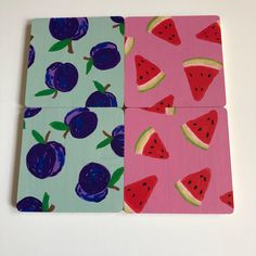 four pieces of paper with fruit painted on them, one is pink and the other is blue