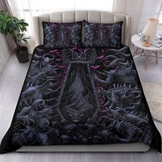 a bed with a black comforter covered in an image of a giant demonic demon