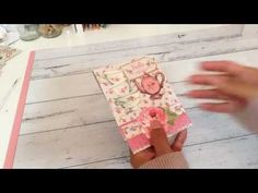 someone is making a card with pink flowers on it