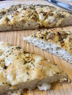 two pieces of bread sitting on top of a wooden cutting board