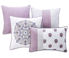 four pillows with decorative designs on them, one in purple and the other in white