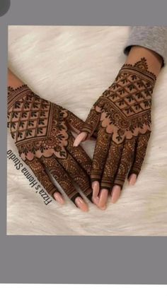 two hands with henna tattoos on them