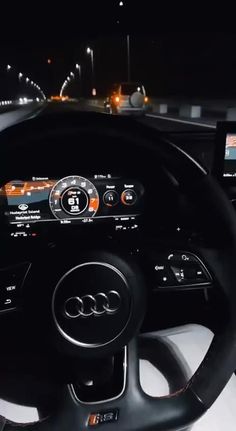 the interior of an audi car at night with dashboard lights and electronic controls on display