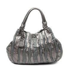 Prada Shoulder Bag Striped Tote In Bronze Pleated Calfskin Leather/Nylon Canvas And Silver Hardware. The Product Is In Excellent Condition (A). Dimension: 40*27*11cm Sku: Aaz5647 Serial Number: Br3994 Accessories Included: None Delivery: We Have A 5 To 7 Business Days Delivery Policy, Hassle-Free And Duties/Tariffs Included! Brandco Paris Finds Rare And Top Condition Items At Great Deals, They Are Worth Your Patience! Shop With Confidence - All Brandco Paris Items Are Carefully Selected And Auth Metallic Silver Evening Bag With Logo Plaque, Metallic Silver Evening Bags With Silver-tone Logo Plaque, Evening Bag With Silver-tone Logo Plaque In Metallic Silver, Luxury Metallic Silver Shoulder Bag, Designer Silver Leather Shoulder Bag, Chic Leather Bag With Silver-tone Logo, Luxury Metallic Bag With Silver-tone Logo Plaque, Elegant Metallic Silver Leather Shoulder Bag, Designer Silver Leather Bags