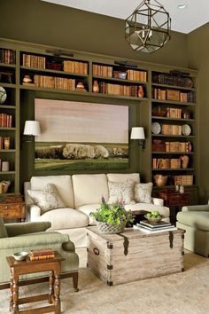 a living room filled with lots of furniture and bookshelves covered in shelves full of books