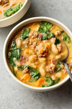 two bowls of soup with meat and spinach