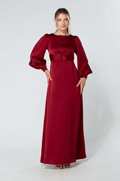 Description Composition Size This stylish maroon maxi dress with wide long sleeves is a refreshing new addition to the ladies' wardrobe. The soft and lavish crepe fabric is very light and smooth. The wide skirt flows gracefully from the waist down to elongate the legs. And the top fits perfectly on the shoulders and gives a flawless accentuated upper body.  Shape: Fitted and Maxi Sleeves: Floating Long Sleeves. Purple Button Closure with Big Cuffs Colour: Deep Red Length: 60 inches or 152 cm (Our model is 172 cm and wearing a size S) Skirt Style: Flowy and Maxi Top Style: Knotted on front and button on back  Neckline: Closed neckline Pattern: Crepe  Zipper: Hidden Zipper Closes at The Side, Elasticated back Fabric: 95% Polyester, 3% Viscose, 2% Nylon. The fabric is very light and airy Occa Maroon Maxi Dress, Crepe Maxi Dress, Wide Skirt, Maxi Tops, Dresses Xxl, Satin Maxi, Satin Maxi Dress, Satin Midi Dress, Lovely Dresses