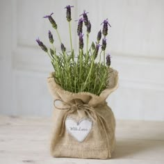 lavender flowers in a burlock bag with a heart tag hanging from the front