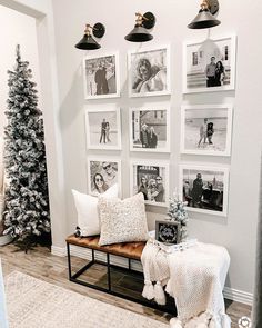 a living room decorated for christmas with pictures on the wall and photos hanging above it