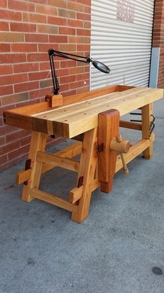 a wooden bench sitting in front of a brick building