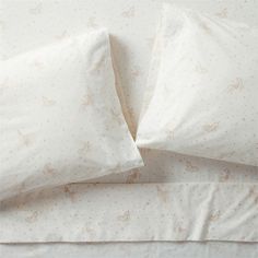 two pillow cases with white sheets and pink unicorns on them