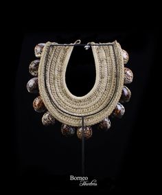 A large Papua New Guinea necklace of cream braided Rope, decorated with three rows of large brown Shells. The largest Shells are 3 inches in length, and the smallest Shells are 2.5 inches in length. The necklace is 4.25 inches in inner width, 13.4 inches in outer width and 12 inches in length, and is attached, at the top, with a cream rope loop, and a circular white Shell toggle. I will ship this necklace via registered Air track and trace (Malaysia Post), 14 -21 working days worldwide. Item shi African Interior Design, Air Track, New Guinea, Shell Necklace, Shell Necklaces, Papua New Guinea, Wedding Necklace, Sea Shells, Crochet Necklace