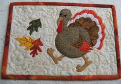 a quilted placemat with a turkey on it