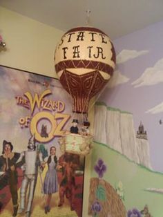 there is a hot air balloon in the corner of this room with pictures on the wall