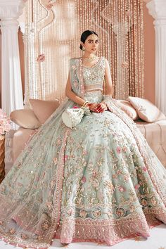 a woman in a wedding dress sitting on a couch