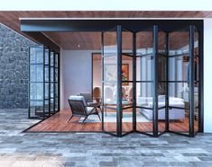 an open living room with sliding glass doors leading to the bedroom and sitting area in front of it