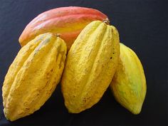 there are three different types of fruit on the table together, one yellow and one red