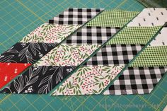 four pieces of fabric are laid out on a cutting board