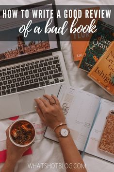 a person sitting at a table with books and a laptop on it, reading the book how to write a good review of a bad book