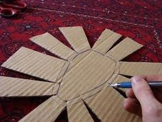 someone is making a paper sunburst out of cardboard