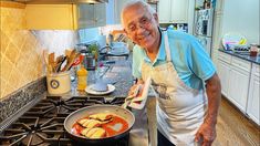 an old man cooking food in a pan on the stove