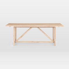 a wooden table sitting on top of a white floor