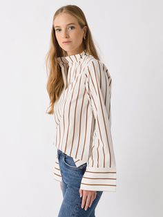 DESCRIPTION:An oversized striped shirt featuring a high band collar, split neckline, and long wide sleeves.FEATURES:Band CollarSplit NecklineWide SleevesAll-Over Stripe Print88% Viscose, 12% PolyamideRelaxed FitModel is wearing size Small shirt.Model's Measurements: Height: 5'9.5" | Bust: 32C | Waist: 26.5" | Hips: 37" | Dress Size: 2-4 (US) Chic Long Sleeve Blouse With Striped Collar, Fall Long Sleeve Blouse With Striped Collar, Striped Blouse For Workwear In Fall, Collared Tops With Vertical Stripes For Fall, Chic Long Sleeve Blouse With Vertical Stripes, Fall Striped Blouse For Work, Fall Daywear Shirt With Striped Collar, Fall Workwear Striped Blouse, Fall Season Striped Collar Shirt For Daywear