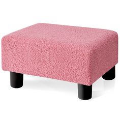 a pink footstool with black legs is shown in front of a white background